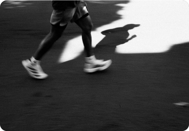 Runners at dusk wearing glow accessories on an urban path